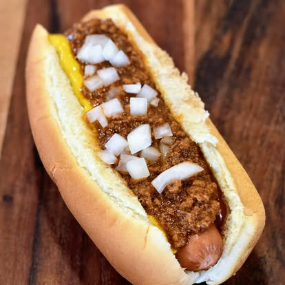 Classic chili dog with mustard and diced onion