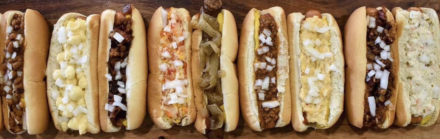 Lineup of loaded hot dogs with different toppings